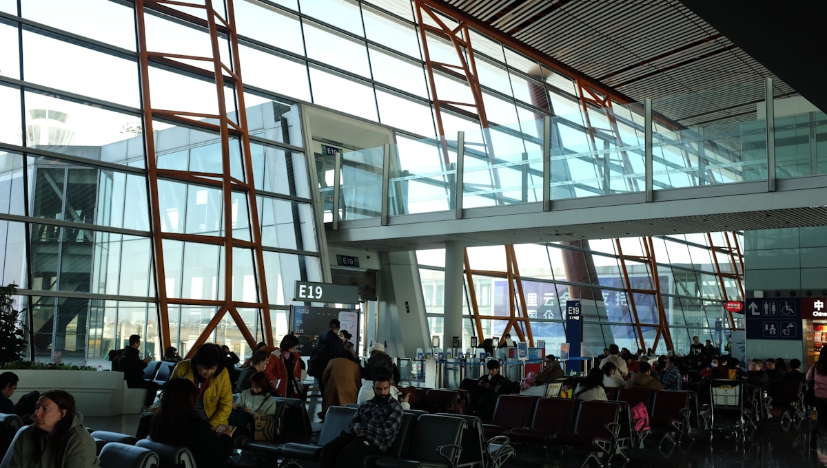 An airport terminal with multiple airline logos and tail fins visible at the gates