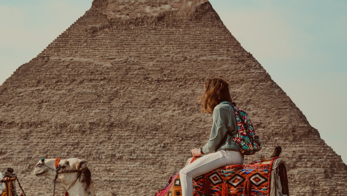 The Great Sphinx and Pyramid of Khafre at dawn with pink and purple sky above the Giza plateau