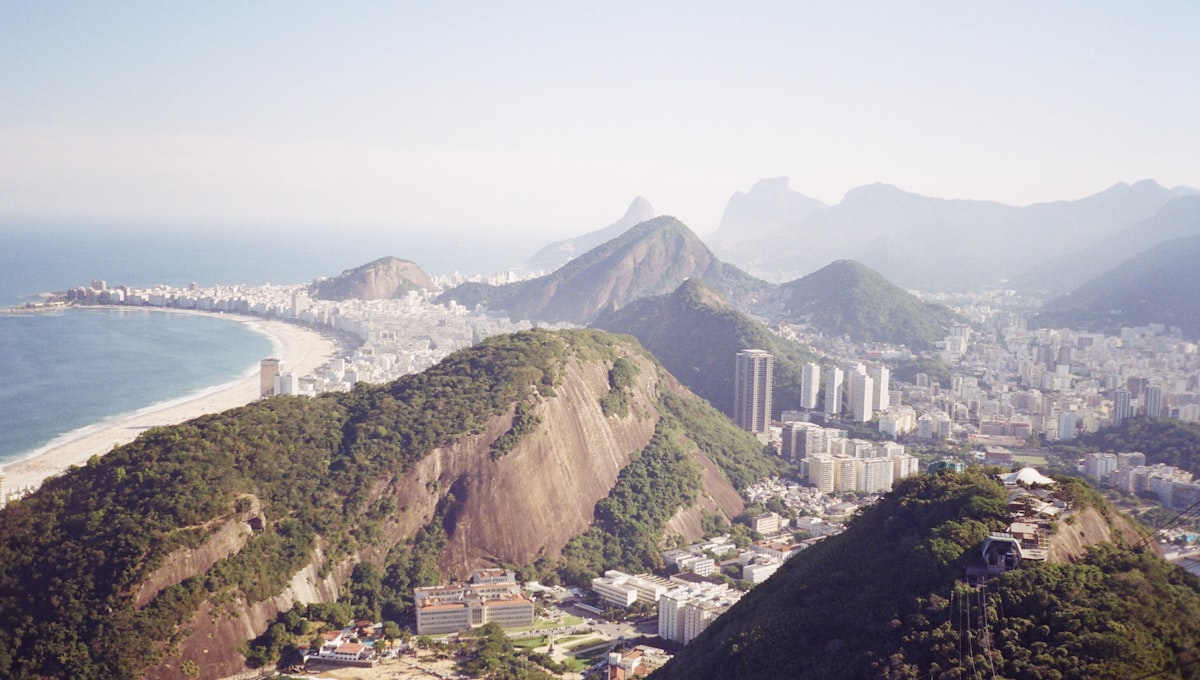 Aerial view of Rio de Janeiro's coastline at sunrise with Sugarloaf Mountain in the background