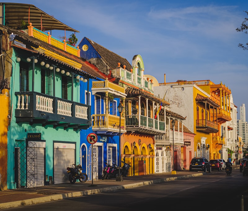 Cartagena's colorful colonial buildings and flower-bedecked balconies in the Old City at dusk with the Caribbean sea visible