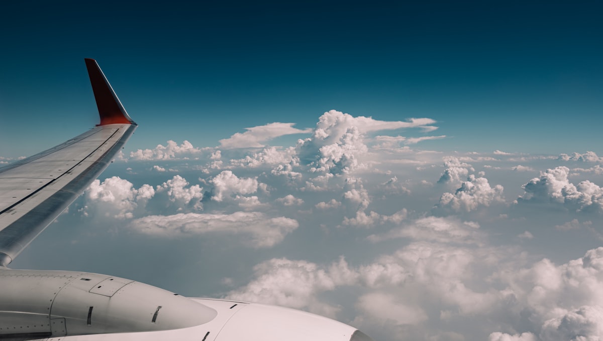 Side-by-side comparison of Google Flights and Skyscanner search results on laptop screen