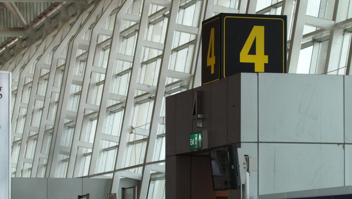 An airline check-in counter with passengers, illustrating the baggage routing problem with hidden city travel