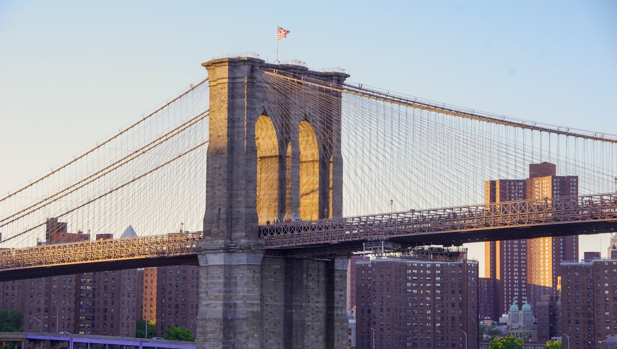 Manhattan skyline at dusk viewed from the Brooklyn Bridge promenade